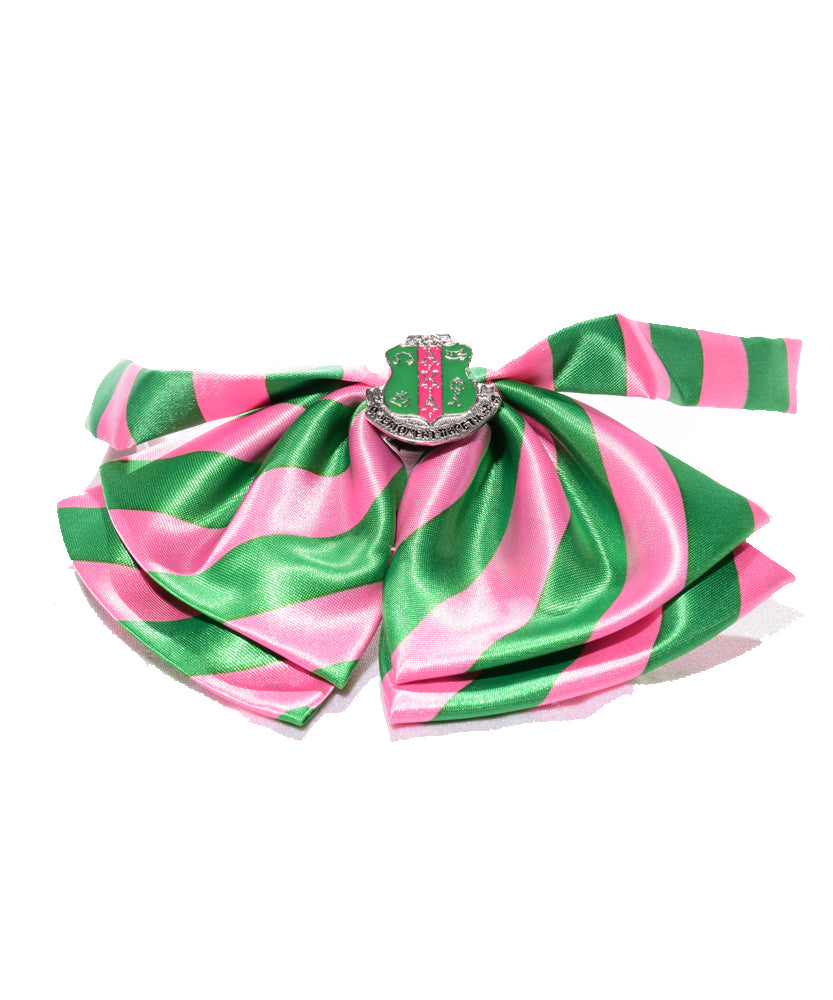 Bow tie pink and green stripes with a shield charm